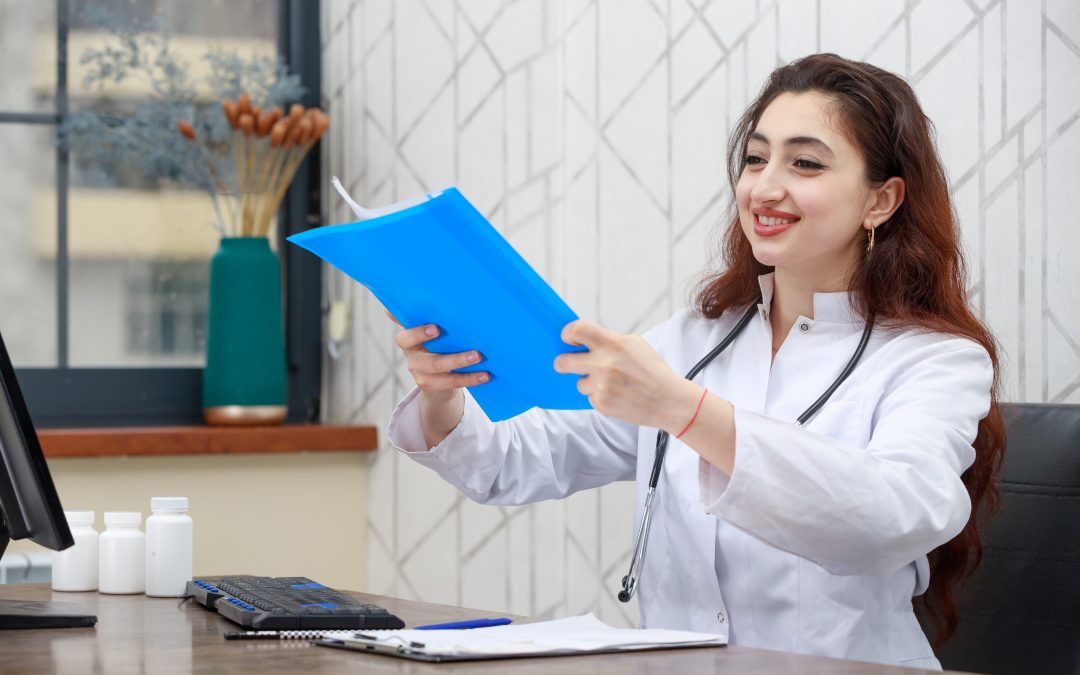 a woman in a white coat is holding a blue folder