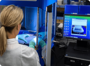 a woman in a lab coat is working on a hp computer