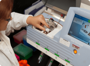 a woman is working on a machine that says ion torrent